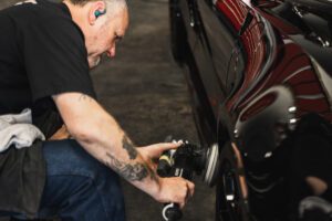 This photo is of an employee at Auto Sport Detailing performing paint correction prior to Ceramic Coating Santa Rosa services.
